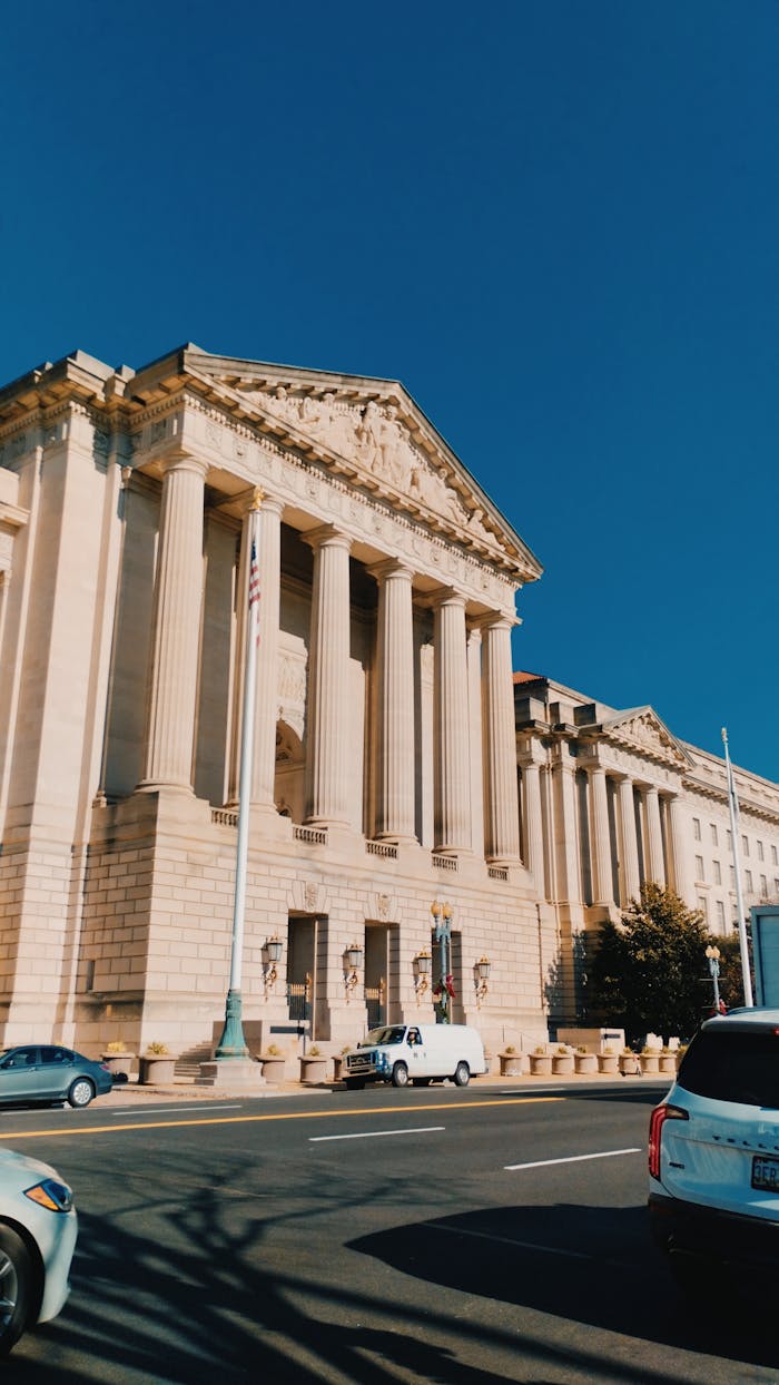 Elegant neoclassical building facade in Washington, DC under a clear blue sky.