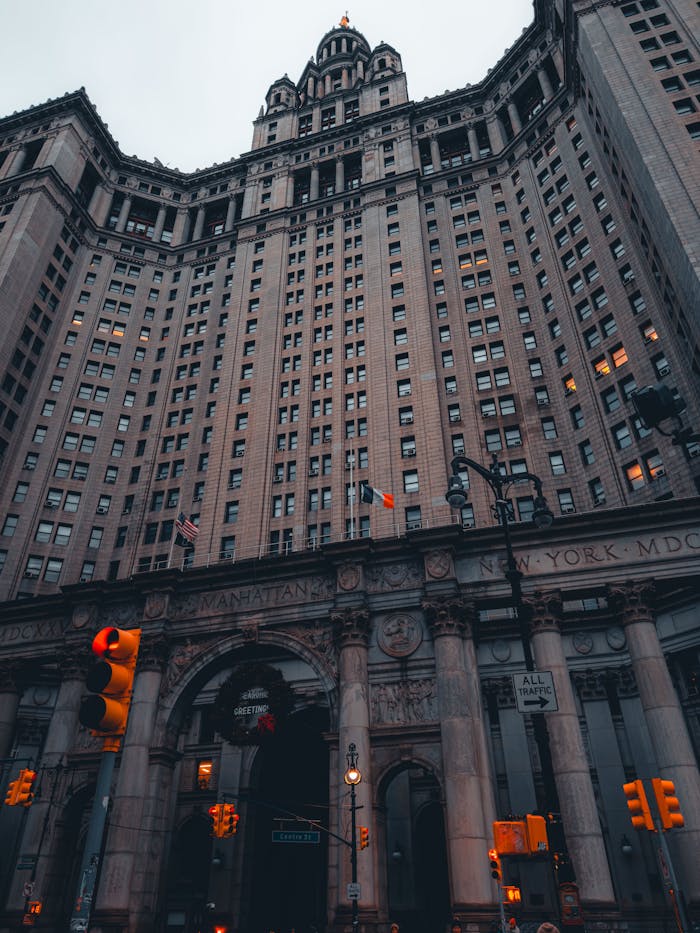 Low angle shot of a grand historic building in New York City with a cloudy sky.